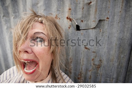 Senior homeless woman with too much makeup screaming