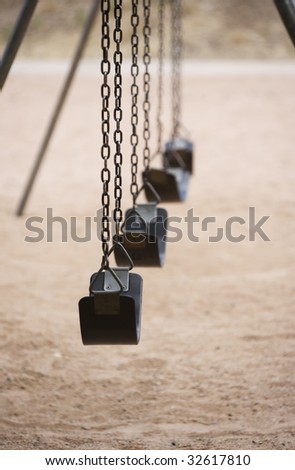 Old style playground swings with chains and rubber seats