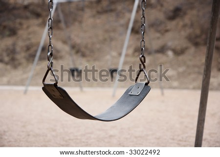 Old style playground swing with chains and rubber seat