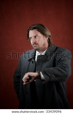 Businessman waiting for someone and looking at watch