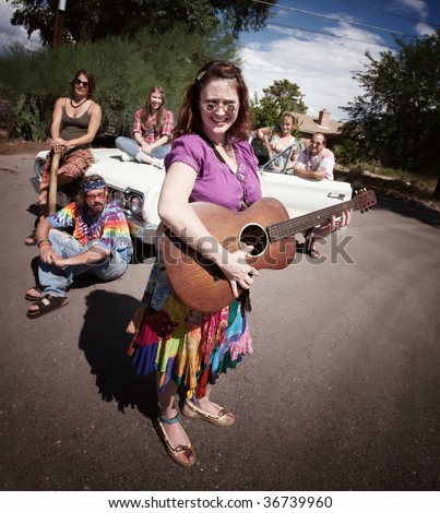 Group of hippies with female guitar player