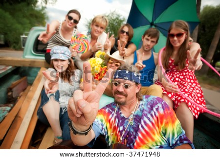 Groovy Group in the Back of Truck Making Peace Signs