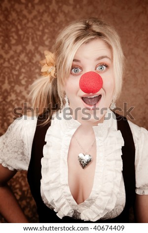 stock photo Pretty young blonde girl with red clown nose