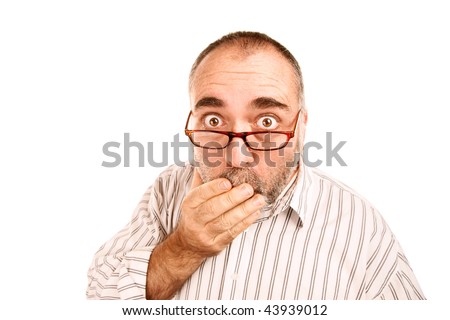 Mature man with hand to mouth and shocked expression