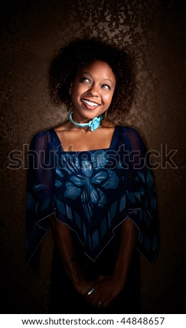 Pretty African-American Woman in Blue Dress on Gold Background