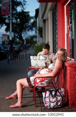 Frustrated and tired pregnant woman resting outside on a chair