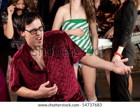 stock photo Nerdy man dancing at a 1970s Disco Music Party