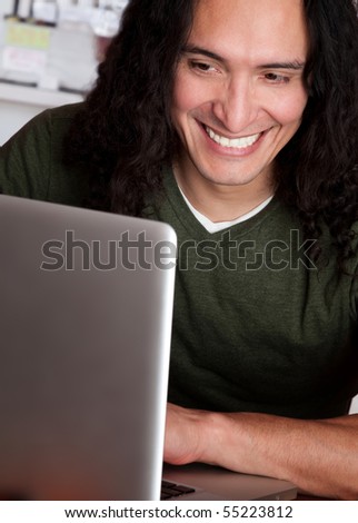 stock-photo-smiling-native-american-male-working-on-a-laptop-55223812.jpg