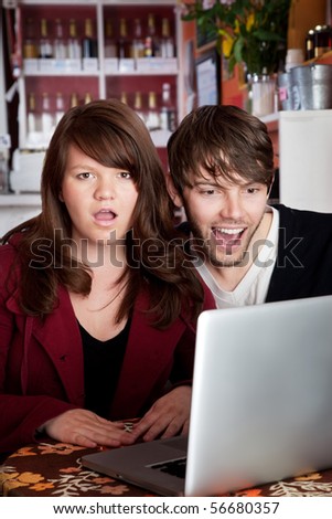 Angry woman shocked with spouse over something on a laptop