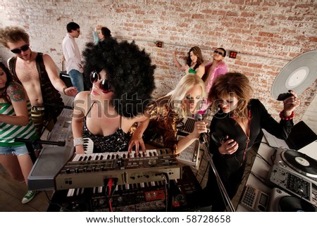 stock photo Three female performers at a 1970s Disco Music Party
