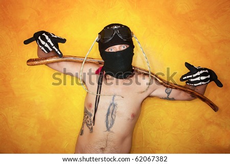 Strange man with arms stretched across a long stick