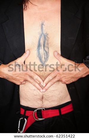 stock photo Mixed race man with feather tattoo on chest