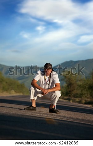 Native American man in the middle of a road