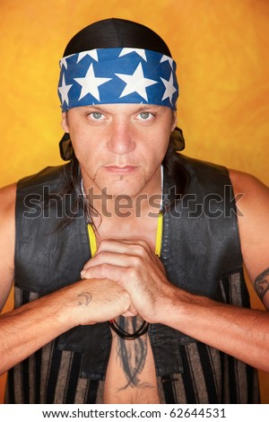 Handsome mixed race man with feather tattoo making fist