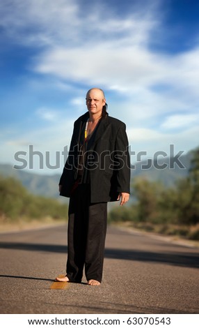 Strange indigenous man in the middle of a road