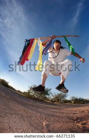 Native American man with colorful flags representing seven directions