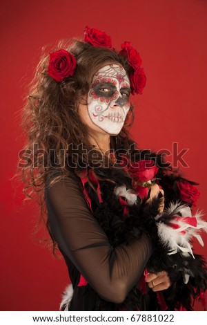 A beutiful woman holding roses and wearing zombie makeup for All Souls Day