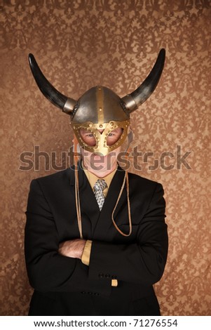 Businessman in dark suit and viking helmet
