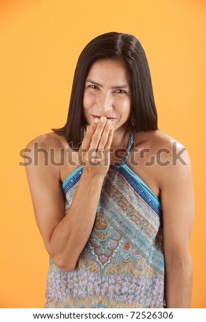 Young Latina woman in sleeveless blouse giggles