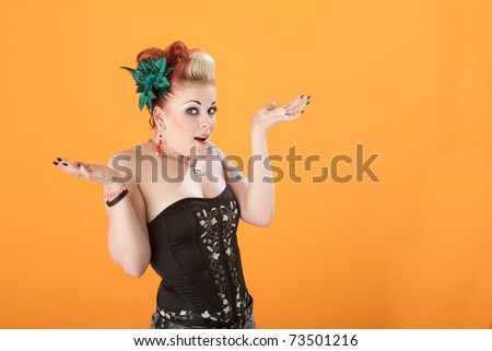 Innocent retro-styled woman with palms raised up