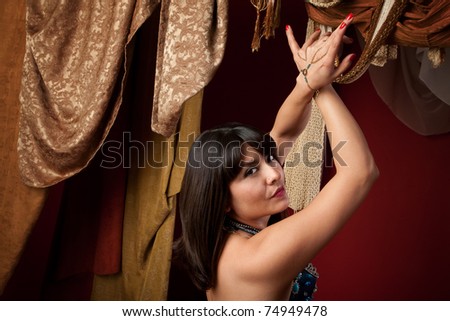 stock photo Sexy Arab belly dancer with hands crossed looks over her 
