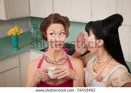 Retro styled woman whispers secret into friend\'s ear