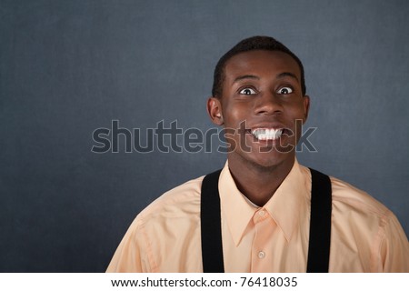 stock photo Happy young Black man on gray background with big grin