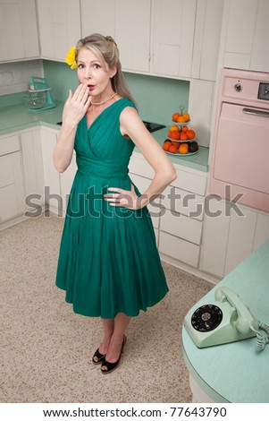 Forgetful middle-aged Caucasian woman with hand on hip in retro-styled kitchen scene