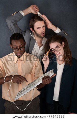 Man and cross-eyed woman work while handsome man combs his hair
