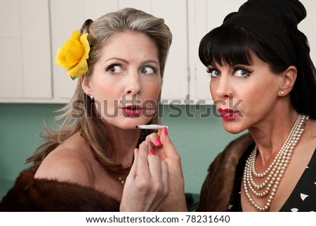 Sneaky rich housewives share a marijuana joint in kitchen