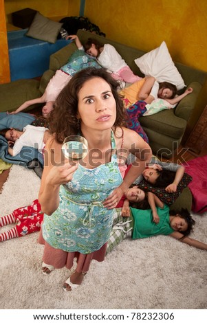 Exhausted  woman with wine and girls at sleepover