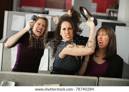 Three women office workers quarreling in cubicle