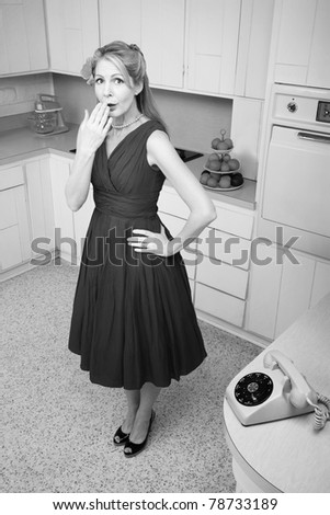 Forgetful middle-aged Caucasian woman with hand on hip in retro-styled kitchen scene