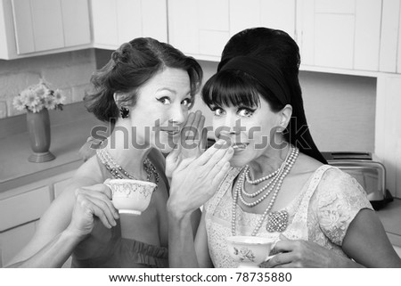 Middle-aged retro styled Caucasian woman whispers secret to her friend