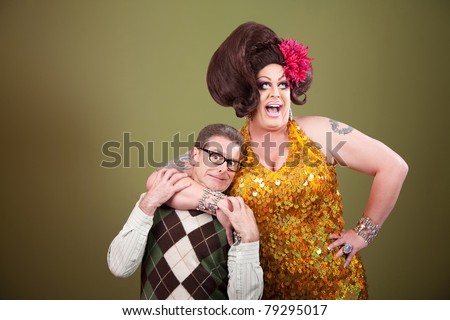 Large drag queen holds a surprised nerd around his neck