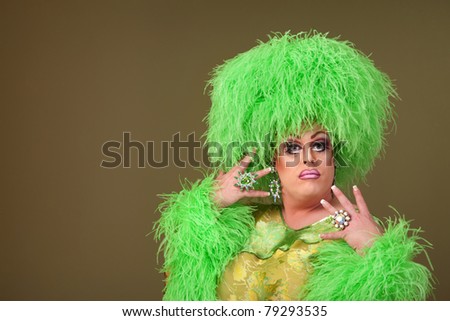 Fancy drag queen in green dress and boa wig