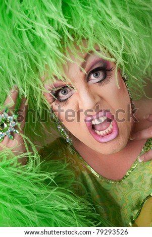 Shocked drag queen in boa wig close-up