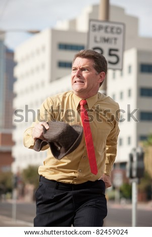Caucasian businessman runs on the streets to make it to meeting on time