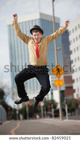 Happy Caucasian businessman jumps in the air