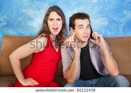 Angry woman listens to man on phone call