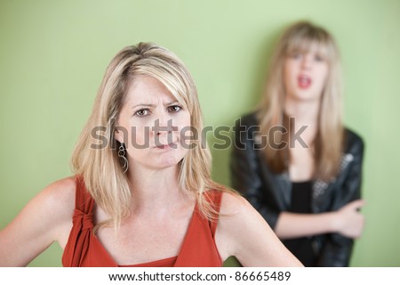 Angry mom with daughter in the background