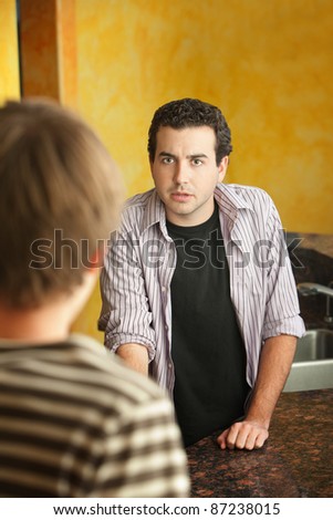 Serious and concerned young Caucasian man with friend