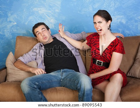 Furious woman gestures to slap boyfriend on face