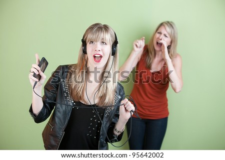 Teen singing out loud with frustrated mom behind her