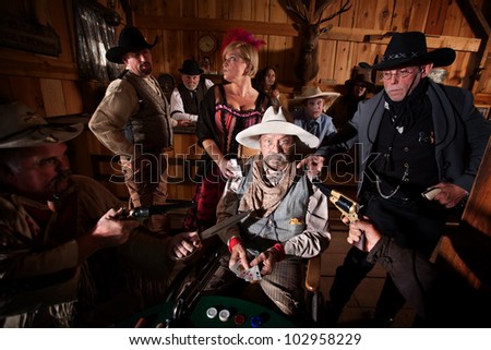 Sheriff and cowboys with weapons on cheating gambler
