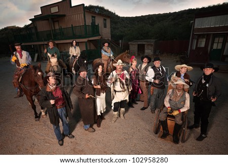 Group of tough people in old west costumes with guns