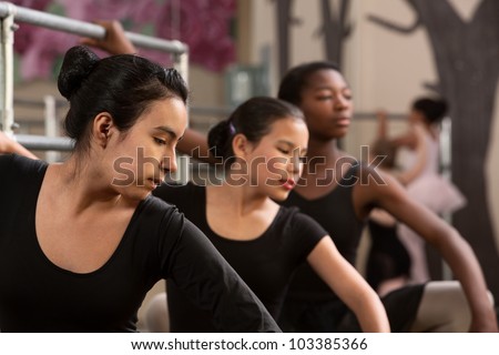 Young Black and Latina ballet students warming up