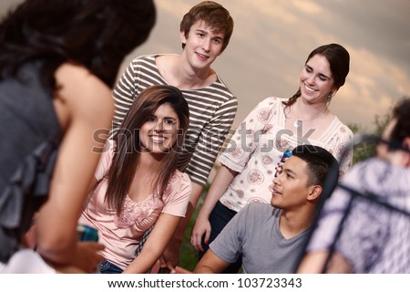 Group of six happy young people outside