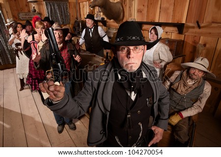 Serious old west sheriff in bar with scared customers