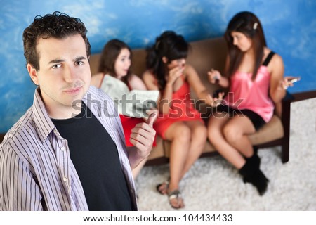 Smirking young Caucasian man with three ladies talking